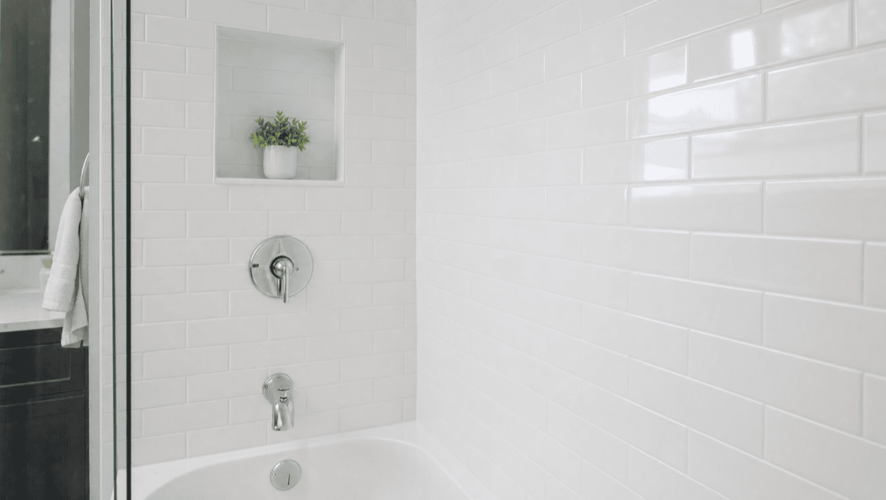 Same shower after tile reglazing — clean bright white