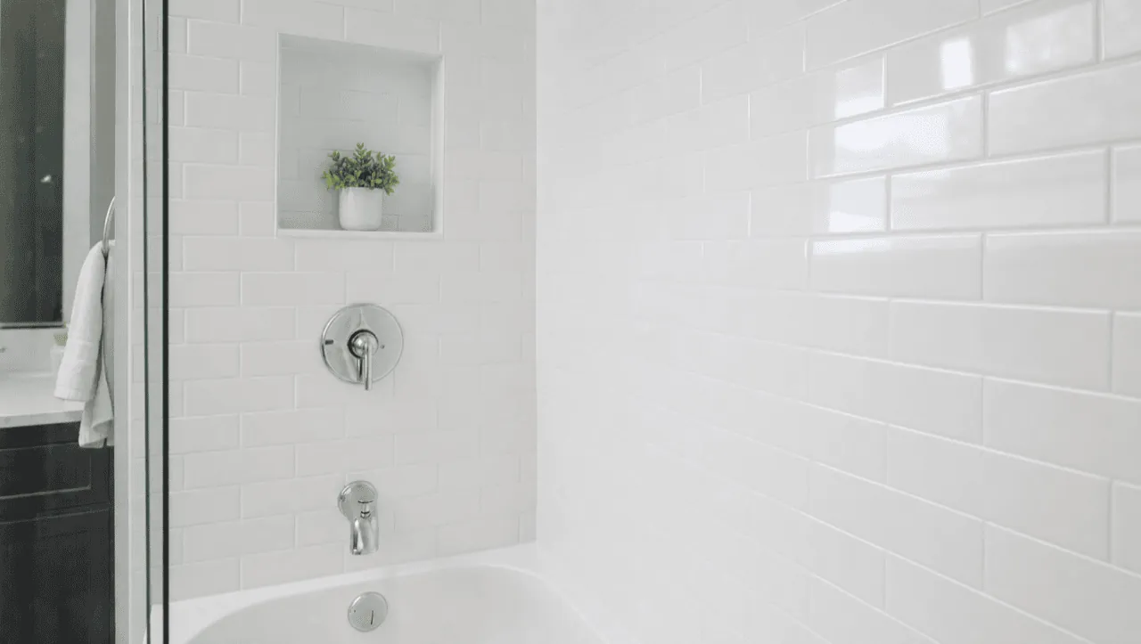Same shower after tile reglazing — clean bright white