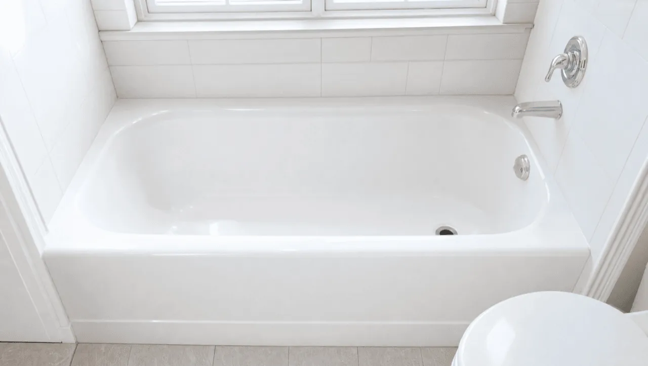 Same bathtub after reglazing — glossy bright white