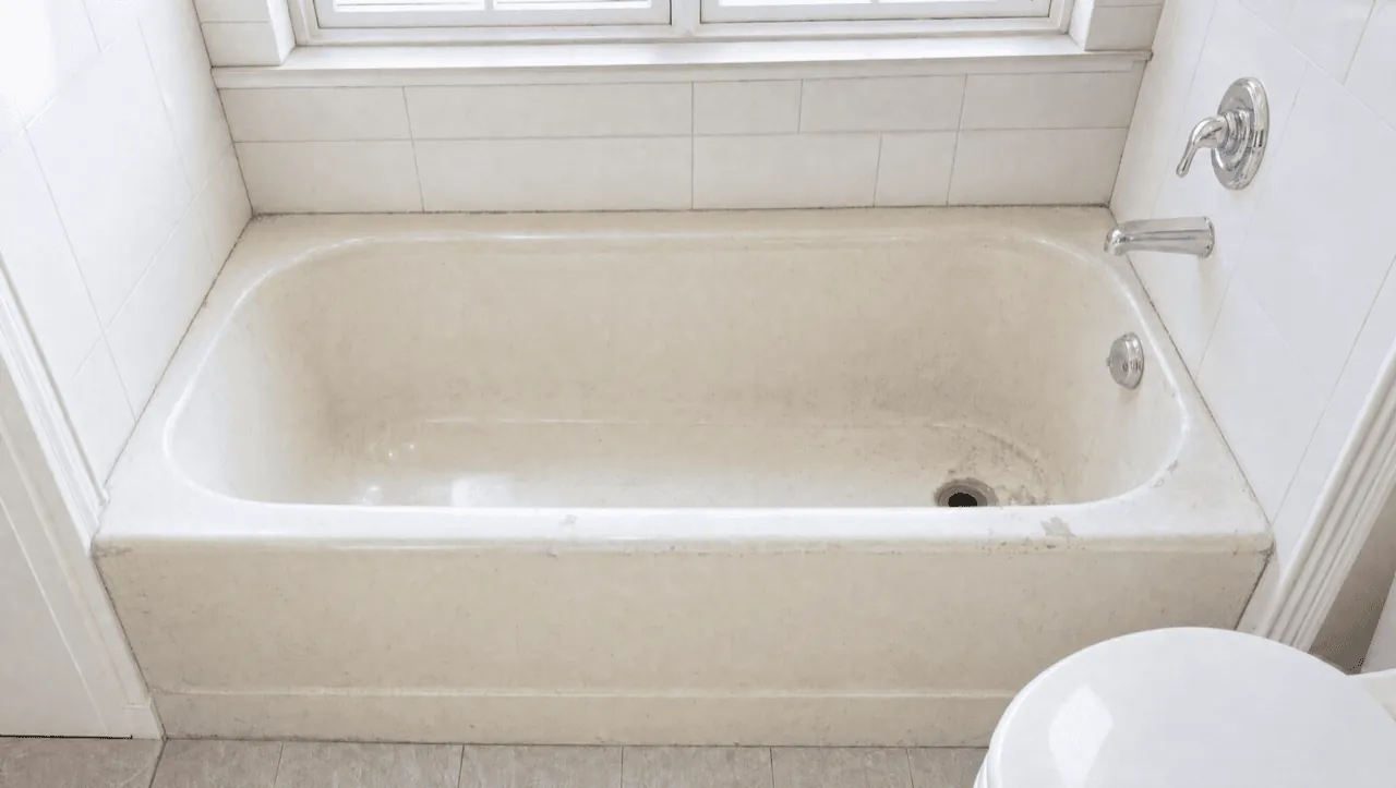 Dated stained bathtub before refinishing in the Bay Area
